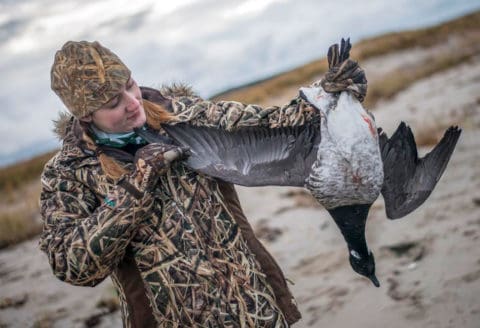 Duck hunter showing the wingspan of her brant