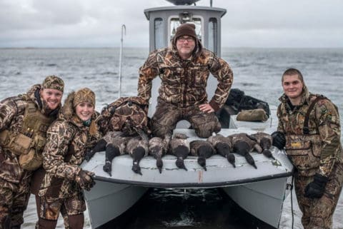 A party of sea duck hunters with their quarry