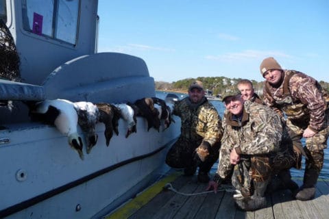 Four hunters with the results of a day on the water