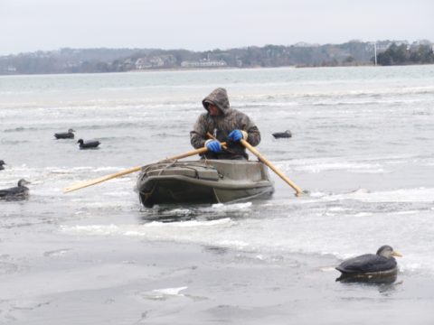 Setting out decoys in icy water