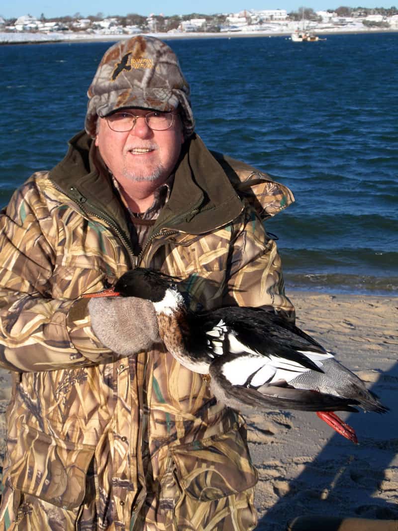 Hunter with bagged sea duck after early morning hunt