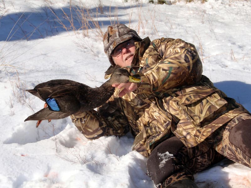 Hunter with black duck