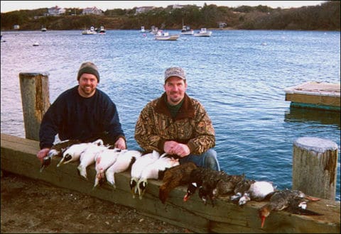 Two hunters display their sea ducks