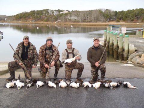 After the sea duck hunt, four hunters display a full quota of sea ducks