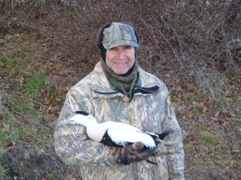 Hunter with an eider