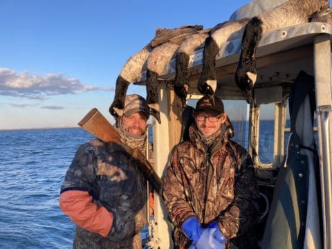 Two sea duck hunters and their quarry