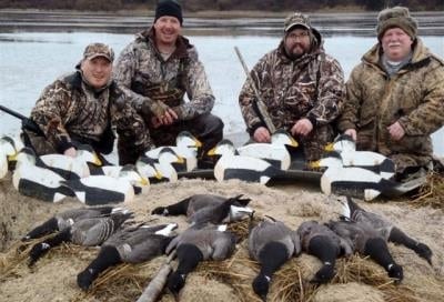 Hunters pose with brant and decoys